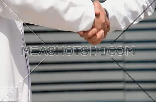 close up of doctor and patient shaking hands