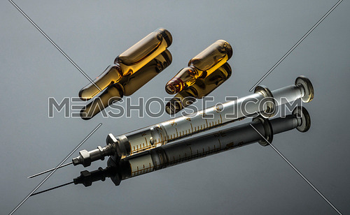 Vintage syringe with vials, conceptual image