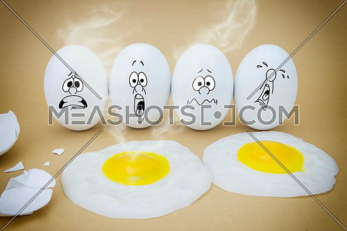 Funny emotional eggs crying and laughing in the box with yolk
