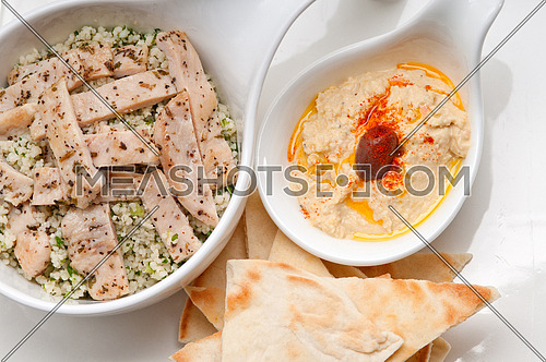 fresh traditional arab chicken taboulii couscous with hummus