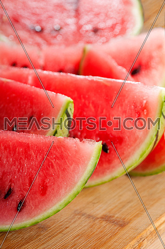 fresh ripe watermelon sliced on a  wood table