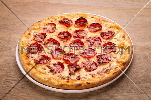Close up shot for Pizza on a wooden background 

