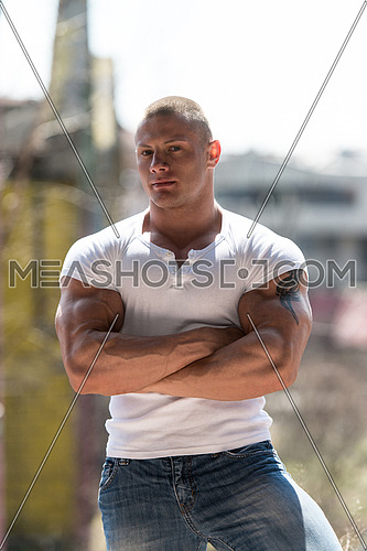 Portrait Of A Physically Fit Young Man Posing In Abondend Ruins