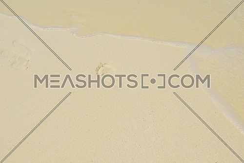footsteps on beautiful white sand beach at summer vacation