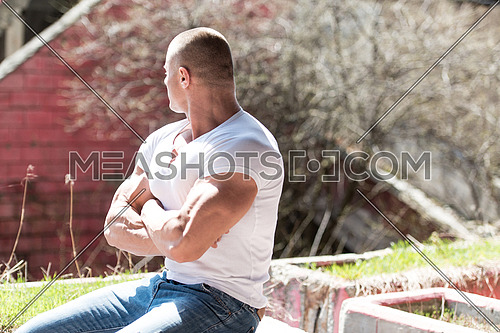 Portrait Of A Physically Fit Young Man Posing In Abondend Ruins