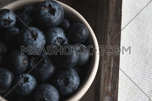 Blueberries in white bowl on a tray