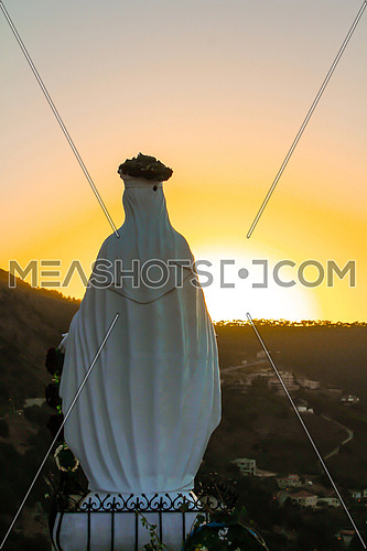 Sunset shot showing the back of a virgin Mary statue
