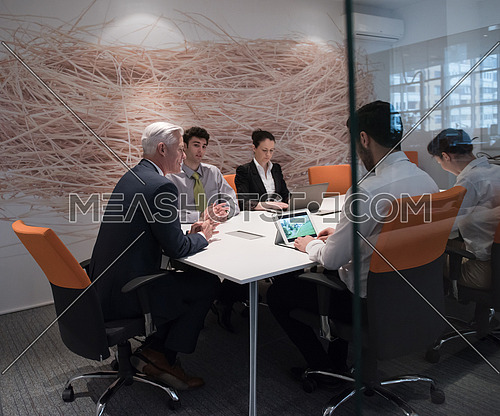 business people group brainstorming on meeting and businessman presenting ideas and projects oon laptop and tablet computer