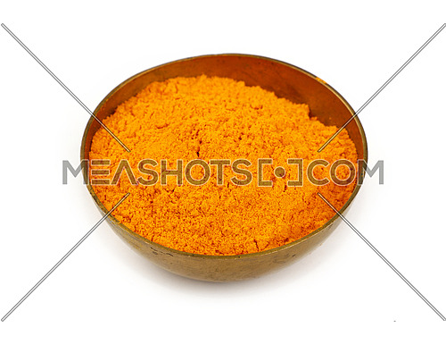 Close up one bronze metal bowl full of yellow turmeric powder spice isolated on white background, high angle view