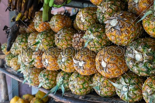 Pineapple stack at grocery on tropical marketplace outdoor,Samana peninsula,Dominican republic.