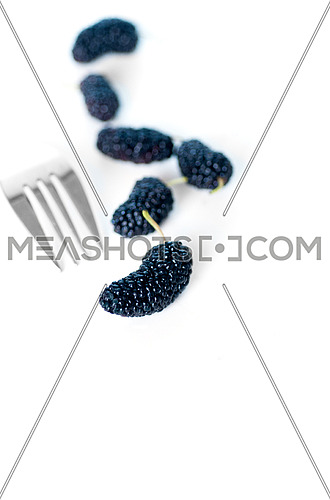fresh ripe mulberry over white extreme closeup DOF with fork