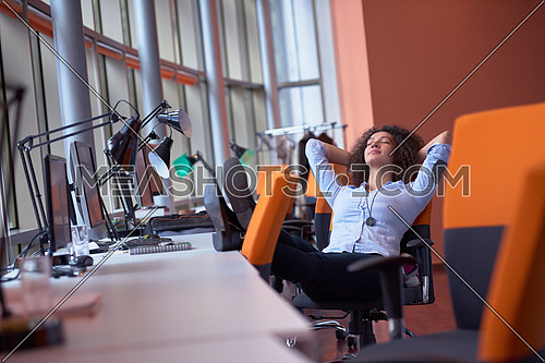 happy young  business woman with curly hairstyle in the modern office