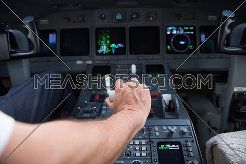 Portrait of a young middle eastern successful pilot in the cockpit