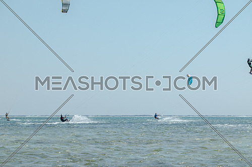 Kite Surfers while surfing in Red Sea at day.