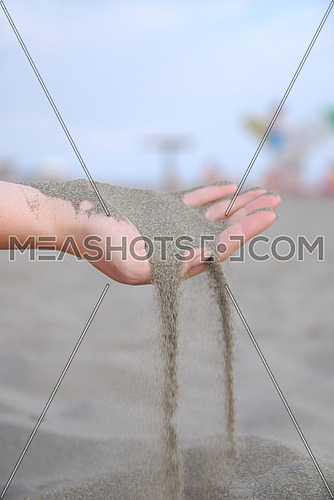 fine sand leaking trought woman hands
