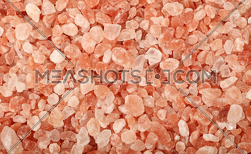 Close up background texture of large crystals pink Himalayan salt, elevated top view, directly above
