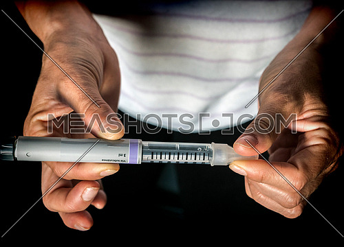 Woman examining treatment of insulin, conceptual image