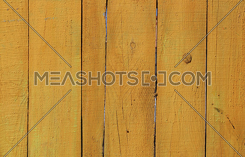 Close up background texture of yellow rustic painted wooden planks, rustic style wall panel