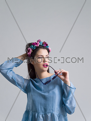 Fashion Model girl isolated over white background. Beauty stylish woman posing in fashionable clothes and sunglasses. Casual style with beauty accessories. High fashion urban style