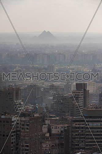 aerial view of GIZA city downtown with Nile and pyramids in the distance at beautiful sunny day with blue sky and clouds capital of Egypt