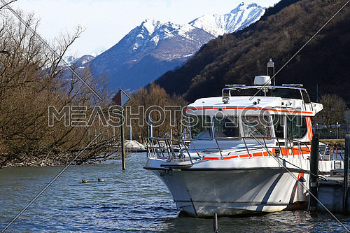 Rescue boat docked in a canal by a lake in the mountains