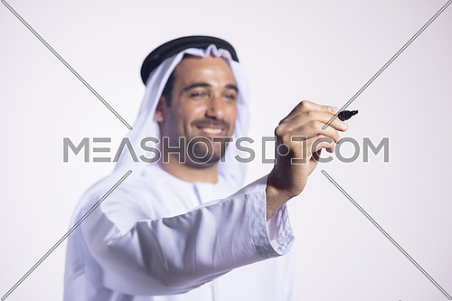 Arabian middle eastern business man writing with  marker on virtual screen
isolated on white