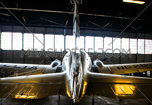 a douglas dc3 in hanger from behind