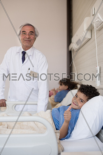 arabian mischievous and beauty kid get treatment by mature doctor in modern hospital
