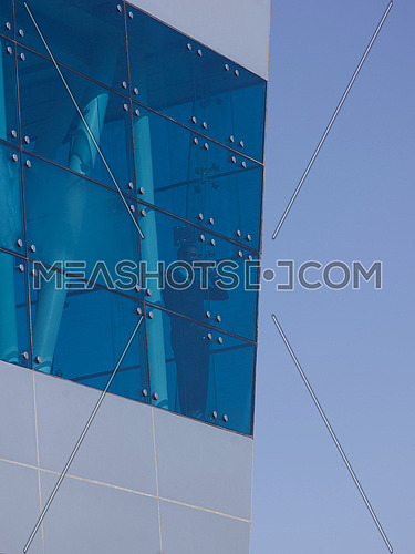 senior business man talking  on mobile phone  at modern office building outdoor shoot with blue sky in background