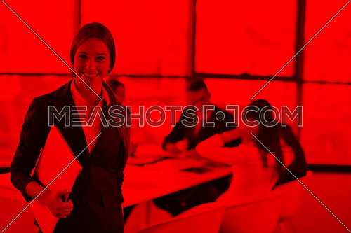 happy young business woman  with her staff,  people group in background at modern bright office indoors