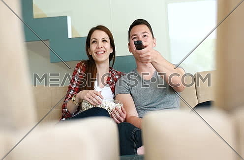 Couple eating popcorns and watching movie