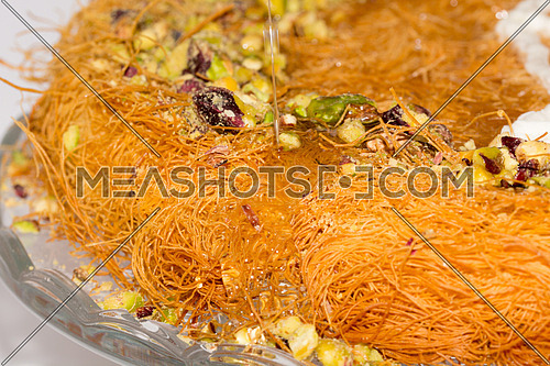 close up on Ramadan Dessert kunafa with honey and pistachio