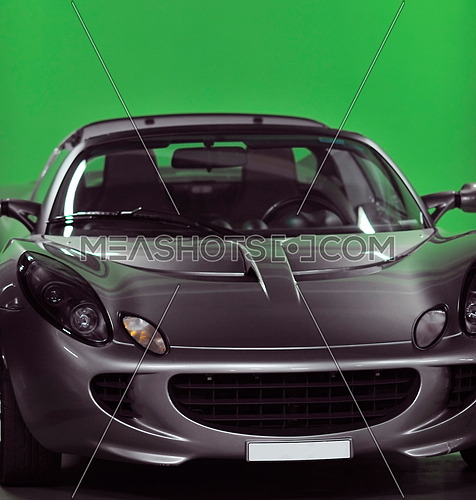 detail of sport silver car with green background