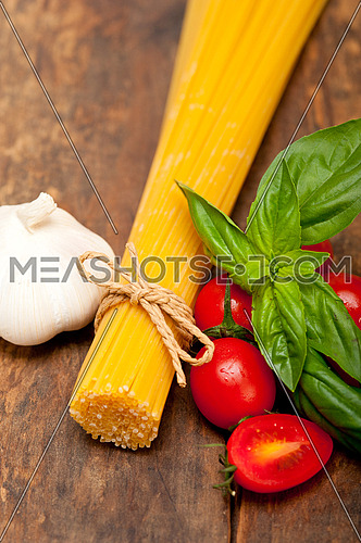 raw ingredients spaghetti pasta tomato and basil foundations of Italian cuisine