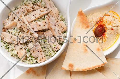 fresh traditional arab chicken taboulii couscous with hummus