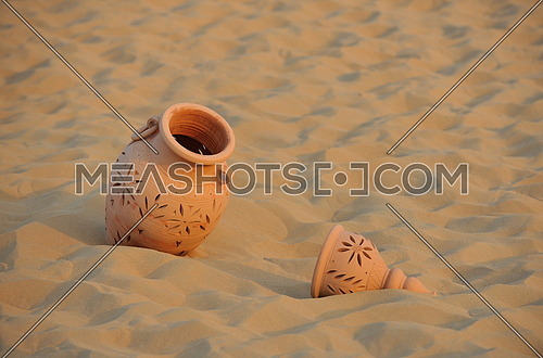 antique art old arabic pot in sand