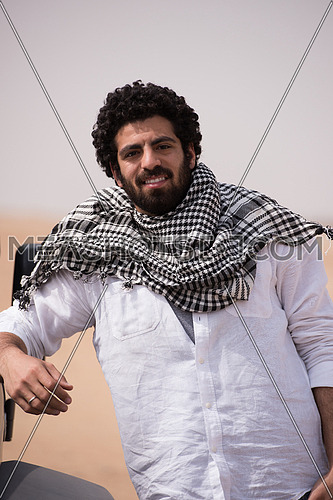 portrait of handsome middle eastern man in egyptian  desert