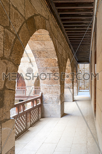 Arch with interleaved wooden balustrades at the arcade surrounding the courtyard of caravansary (Wikala) of al-Ghuri, Medieval Cairo, Egypt