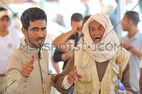 old egyption man and his son after voting in the 2018 Egyptian presidential elections in the peace city of Sharm El-Sheikh in South Sinai on the first day of the elections 26 March 2018, which lasts for 3 days