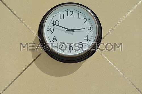 classic vintage wall clock on yellow background