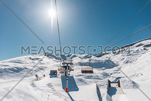Ski lifts durings bright winter day