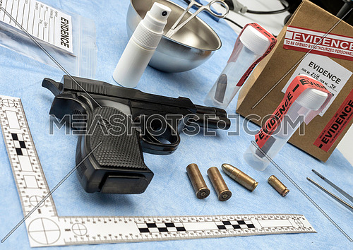 Criminalistic Laboratory, Firearm next to bullet cap for ballistic analysis, conceptual image