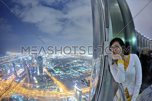 beautiful woman relax on balcony with  amazing night city view in background