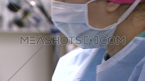 Close up shot for Nurse face working in operating room