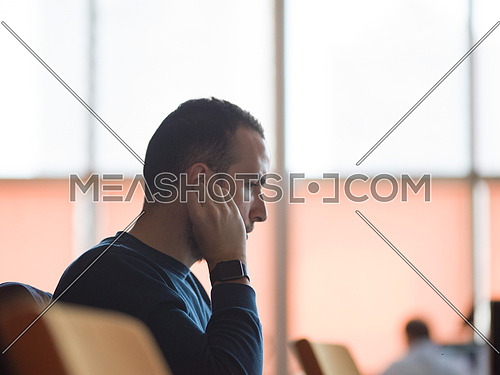 young business man listening music on headphones at modern startup office