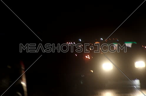 mid shot and zoom out for cars driving at night