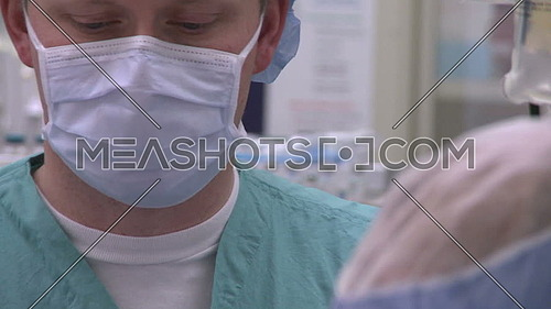 Close up for surgical technician using cell phone during surgery