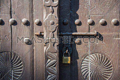a vitage old wooden door with lock