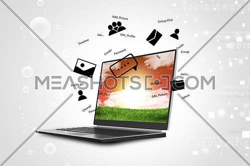 Laptop on green grass in color background