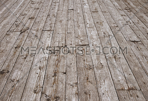 Old vintage rustic aged antique wooden planks floor surface with gaps, diminishing perspective, high angle view